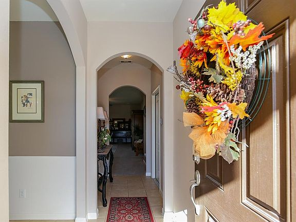 Welcoming double entry with tile floors and rounded archways!
