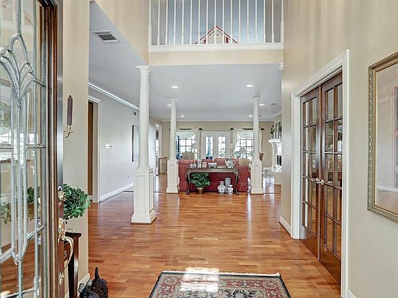 Enter through the beveled glass front door into the dramatic two-story entry. The door to the study is pictured to the right.