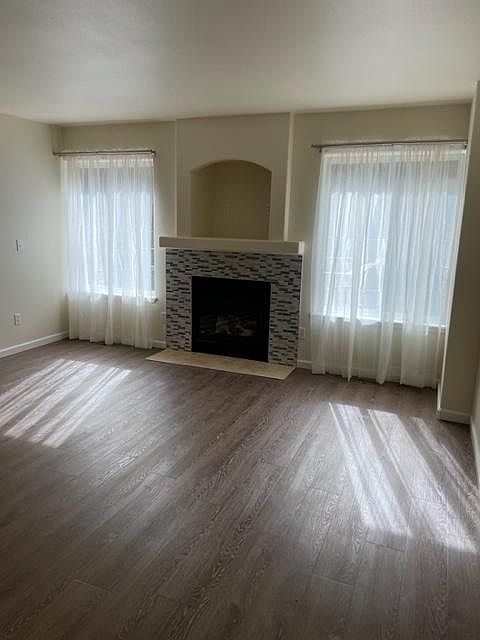 Living room gas fireplace. Double curtain rods. Shear curtains come with rental. Double rod for personal curtain choice for privacy and light blocking.