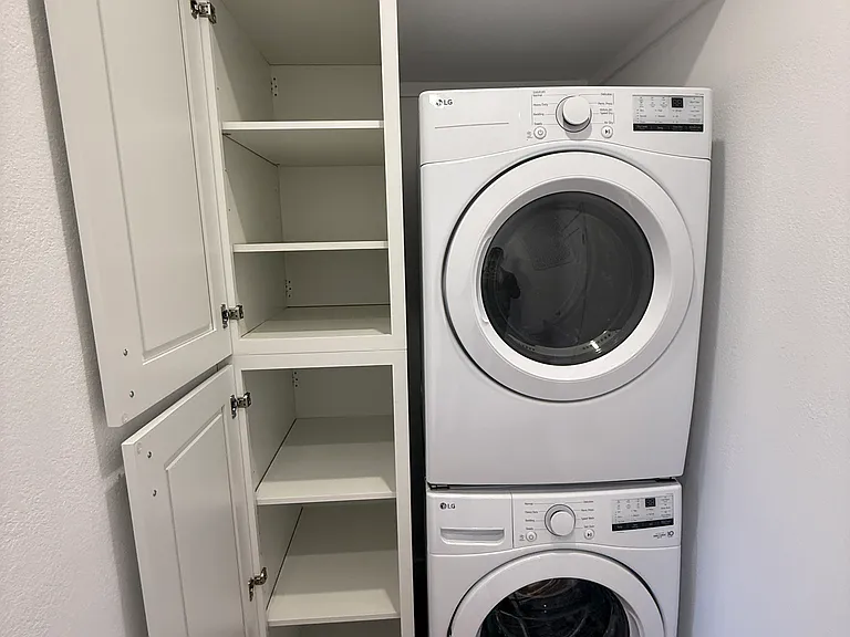 Separate in-unit full sized LG washer and dryer plus loads of linen and towel storage