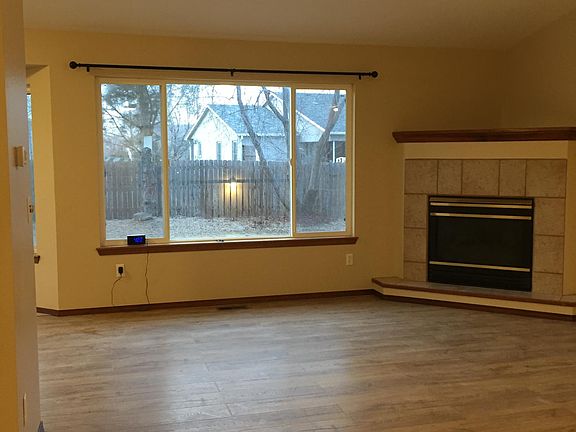 o Living room (27_ x 14_*) with gas fire-place, patio door, new laminate wood flooring.