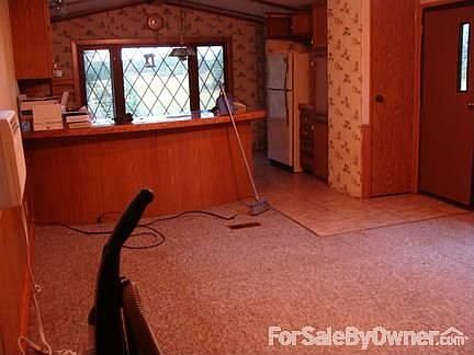 view from livingroom into kitchen and out the window.