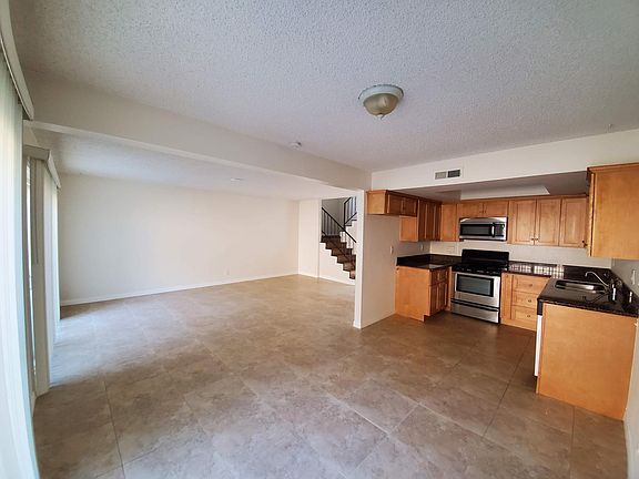 Full view of kitchen/dining/living areas. Photo taken from patio door entrance.