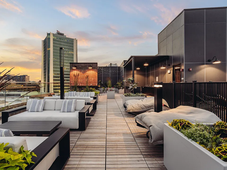 Rooftop lounge area featuring poolside seating and cabanas
