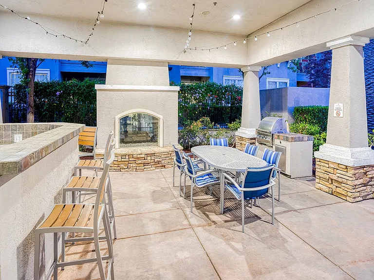 Grill stations, covered outdoor dining area with a fire place, poolside
