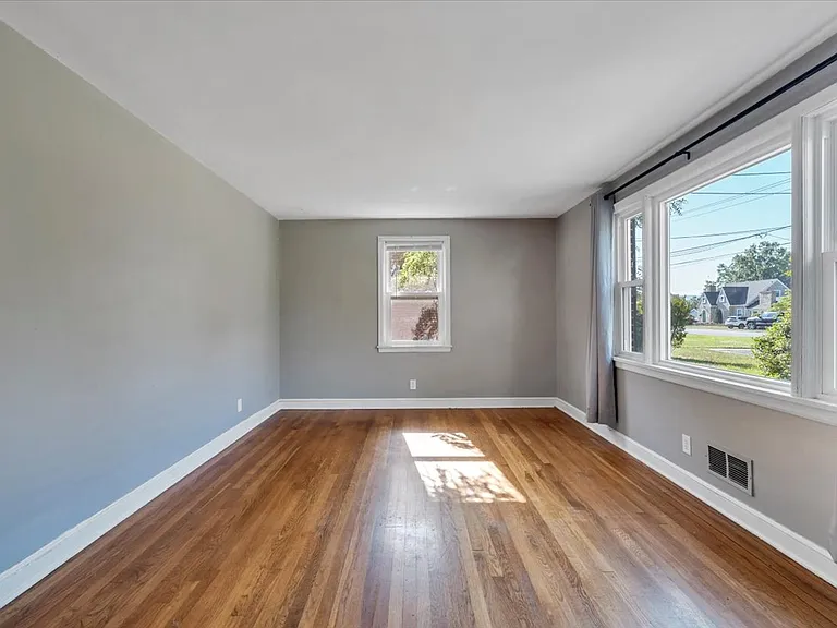 Spacious Living Room w/ Two windows, One is a Bay Window! NEW Black Matte Curtain Rods Installed by Landlord!