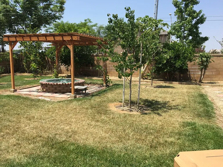 Yard is in the process of redoing with grass or rock/gravel..