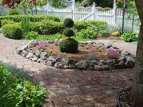 The previous owner was a master gardener and added most of what you see in the photo including pavers, rocks and plants.