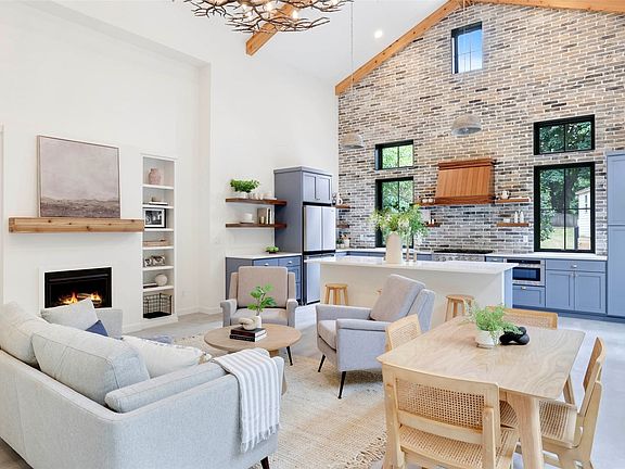 This view showcases the abundance of natural light and grand feel this great room offers.>
