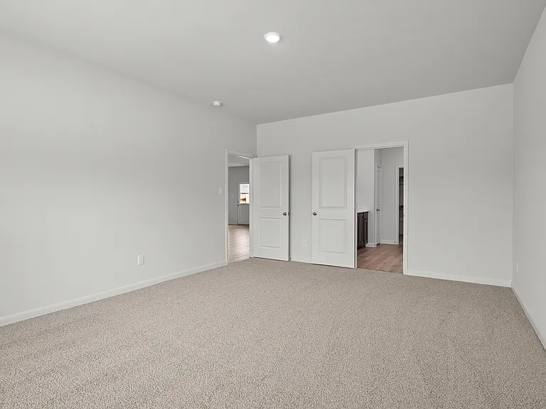 The master suite has a large bedroom, ensuite bathroom and a walk-in closet.