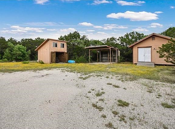Multiple out buildings onsite.  The building on the right is a very good sized workshop with power to it.