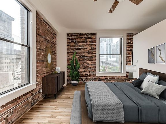 A view of the primary bedroom! The 2 windows provide this space with views and a great amount of natural light. This photo is virtually staged.
