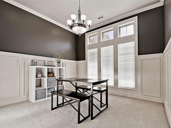 Formal Dining Room just off Front Entrance Features Beautiful, Architecturally Significant Wainscotting, Updated Walls and a bank of 3 floor to ceiling windows for plenty of light...