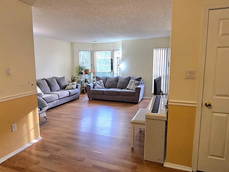 Large living room with lot of natural light, a big coat closet and an open layout.