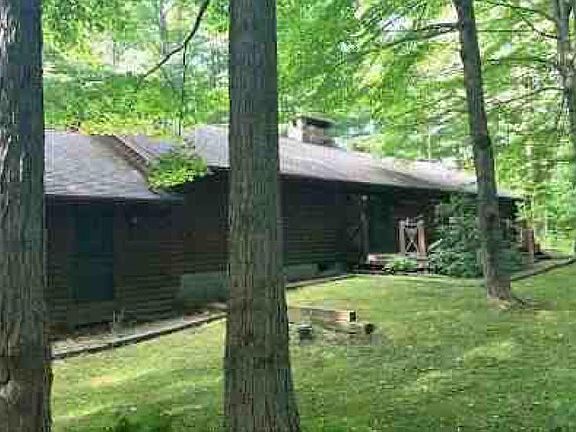 Spacious back yard with attached wood deck.