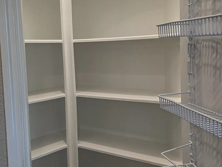 Large walk-in kitchen pantry with added door storage for easy organization
