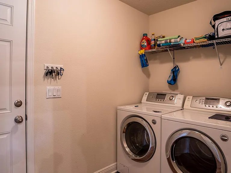 Laundry room adjacent to garage
