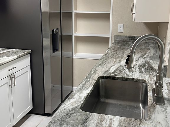 Stunning new granite counter tops highlight the kitchen, a perfect size for two for cooking and lots of counter space.