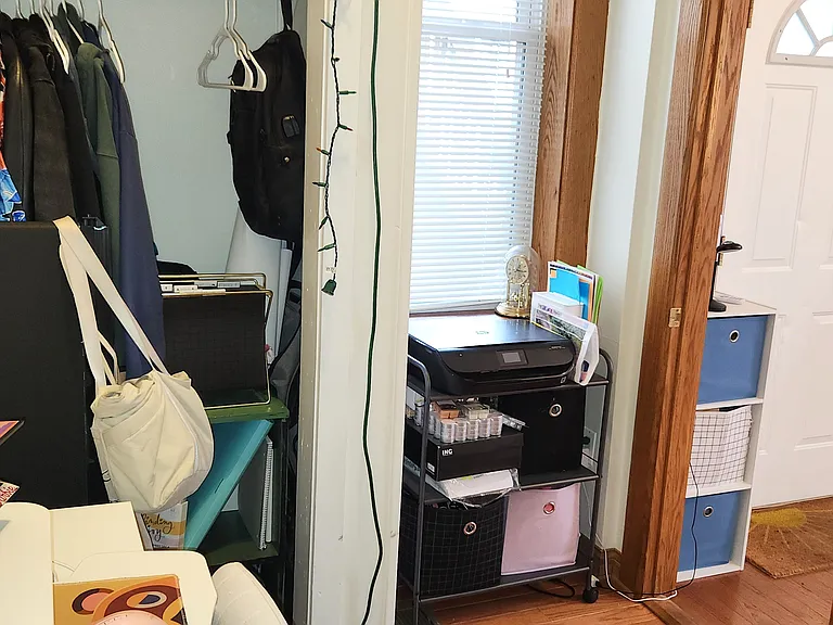 Small bedroom/ office closet, window and view out open door toward living room and rear entrance