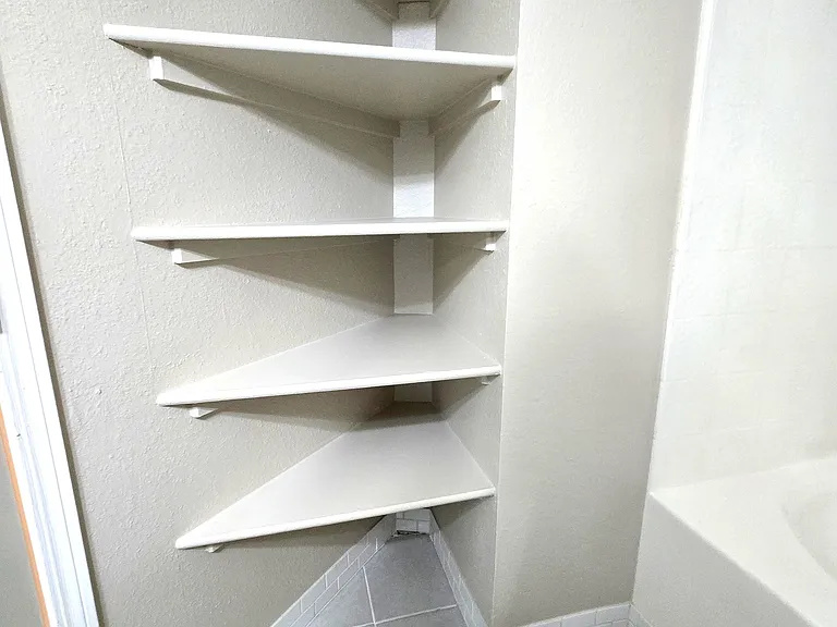 Plenty of shelves in bathroom