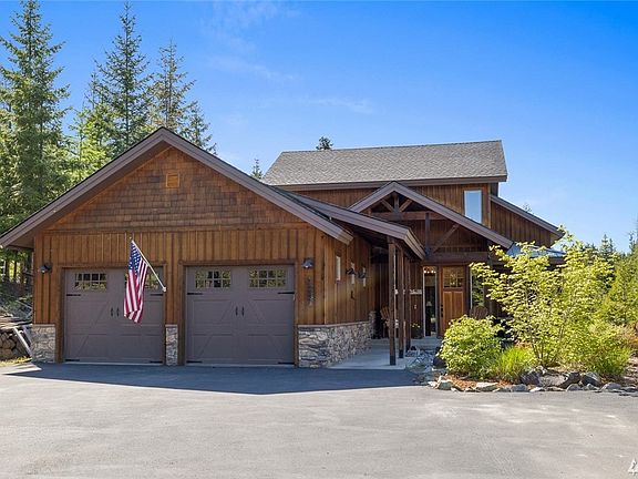 Barely viewable from the road, the fully paved drive with extra parking space beckons you to this lovely retreat.