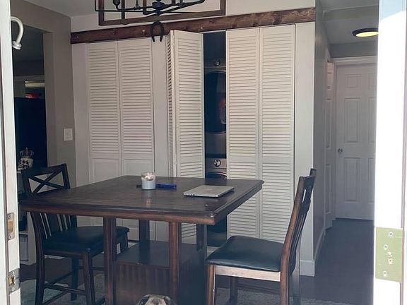 Main entrance to Living room 1. Stackable laundry behind closet doors along with coat hangers and laundry storage