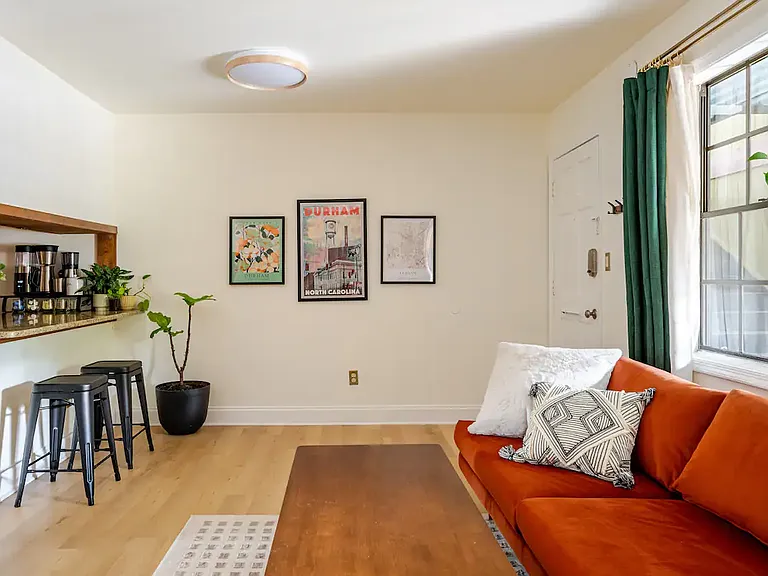 Living Room / Dining Area (There is actually a small dining table with two chairs under the pictures on the wall.)