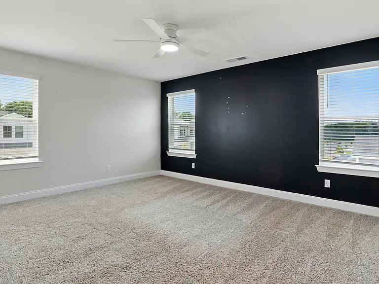 Master Bedroom - Large primary suite with plenty of natural light and space for a king-sized bed and additional furniture.