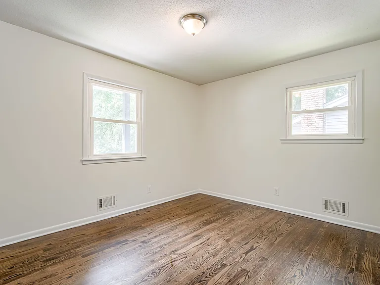 Bedroom2 upstairs features a window overlooking the driveway and another overlooking the side yard