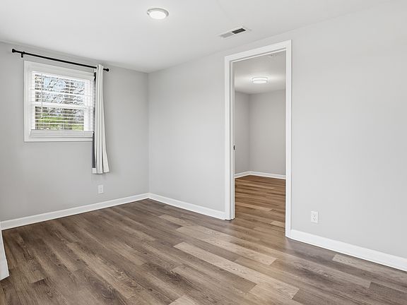 Inviting entryway with updated flooring, fresh paint, and space for convenient storage or a drop zone.