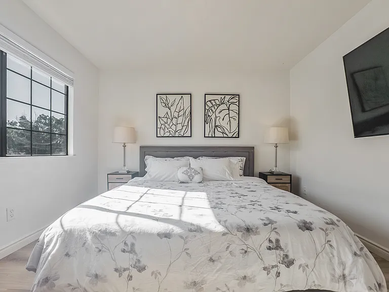 Bedroom # 1 with a king bed, work station, smart TV, and en suite full bathroom