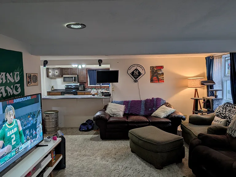 Large living room with breakfast bar open into kitchen.