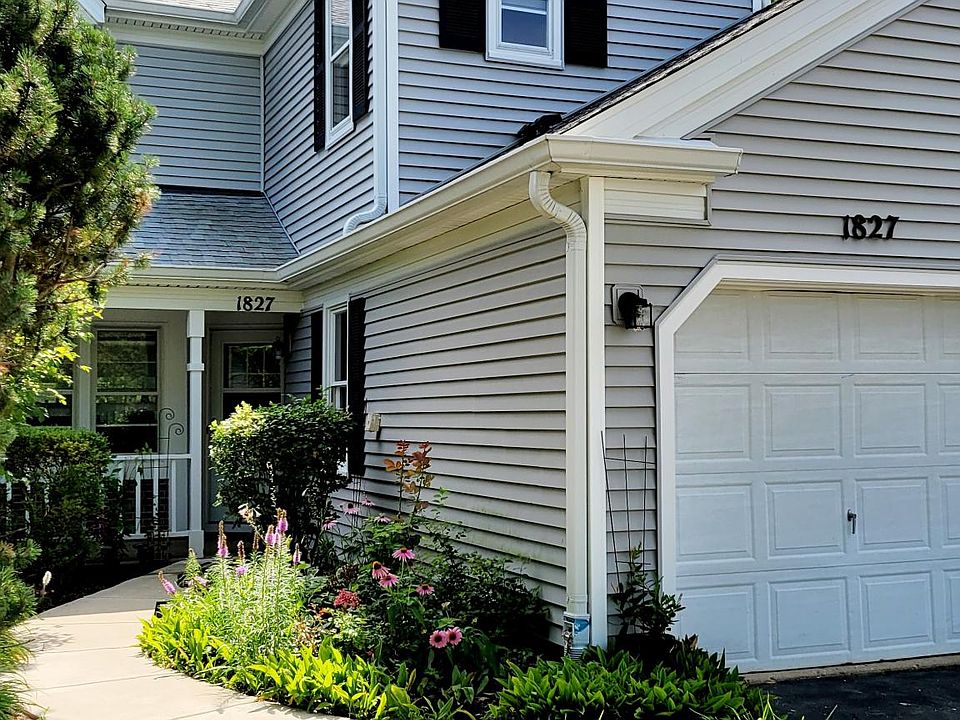 Front entrance with porch and beautiful flowers.