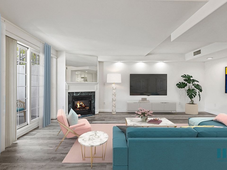 Living Room with Patio, Large-Size Windows, Electric Fireplace, and Vinyl Flooring