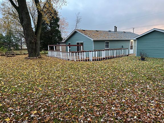 Back of house with large wrap around deck