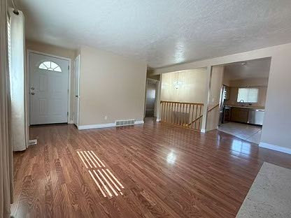 Front door, open floor plan to kitchen.