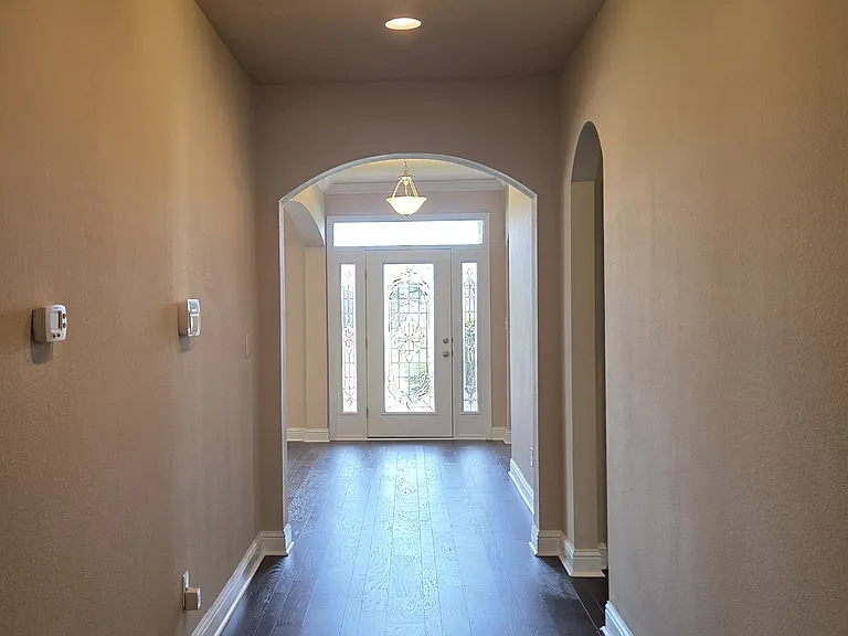 Hall way facing front door.