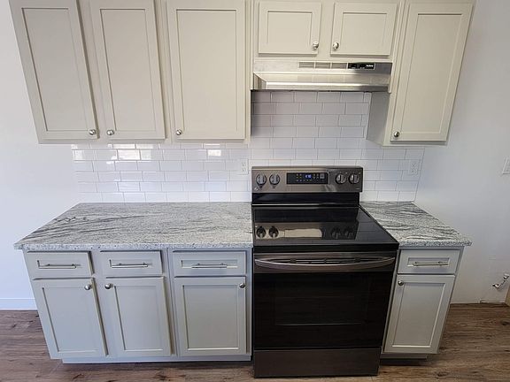 New Kitchen Cabinets and granite countertop with white subway tile backsplash