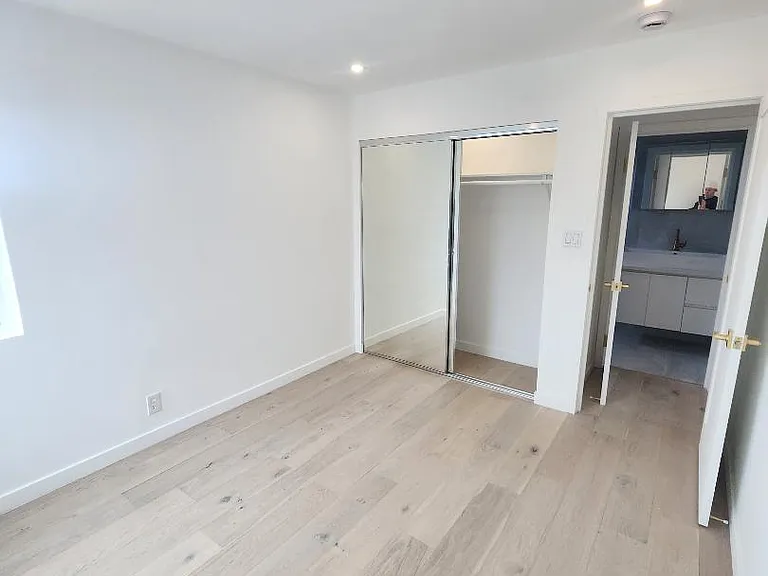 Bedroom showcasing mirrored closet