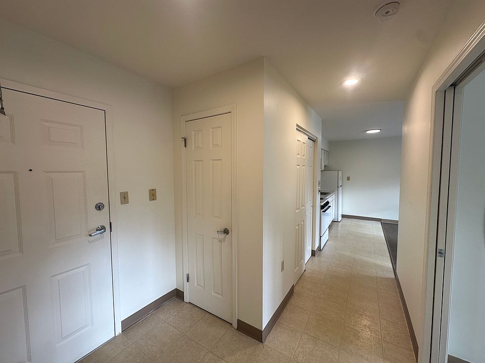 Entry foyer, Coat closet, Hallway to kitchen living room and both bedrooms.