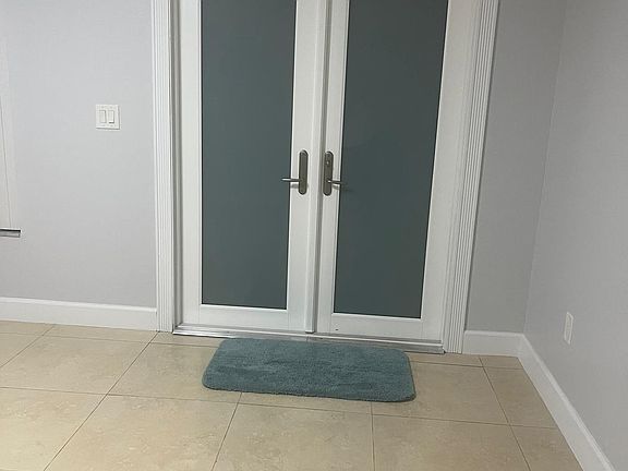 Front entrance leading to the living room.