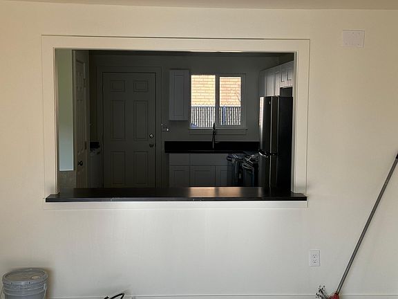 Living room and kitchen are connected with passthrough and small countertop.