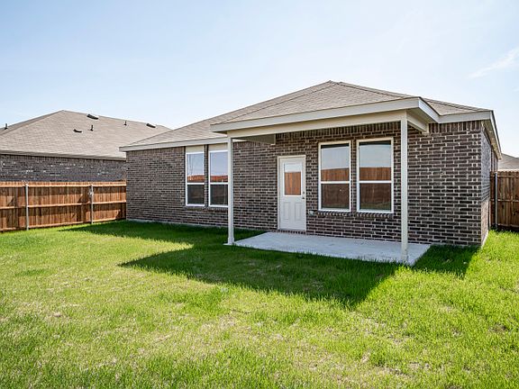 Spacious, fenced-in backyard with covered patio.