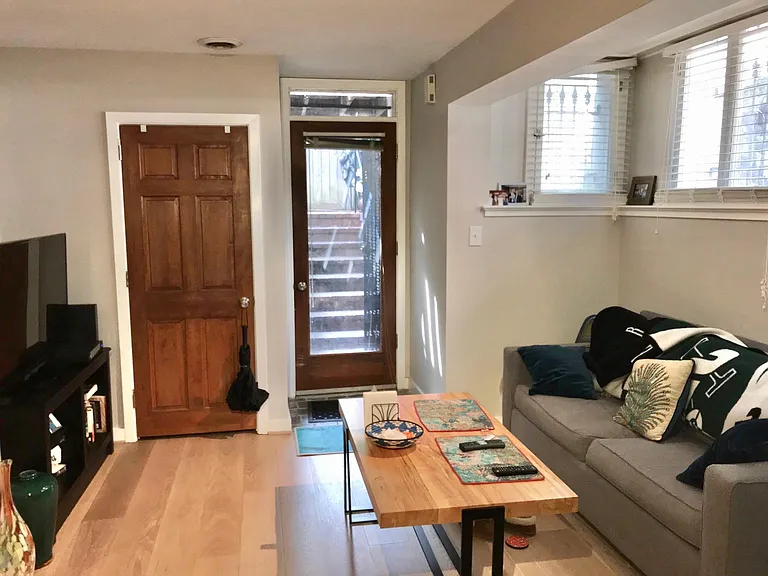 Seating area & TV in the living room with lots of windows and nook