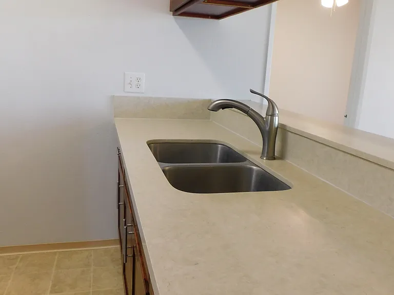 Newer kitchen cabinets and countertops. Disposal.