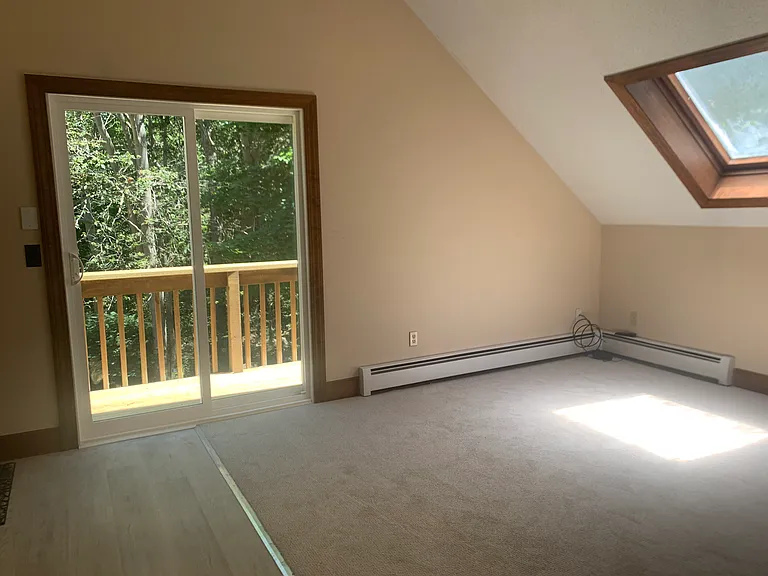 New carpeting and sliders to private deck in living room