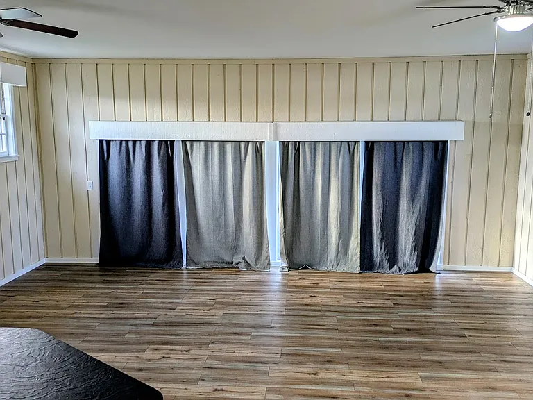 A large bonus/recreation room with a built in bar area with a sink. 20x20.