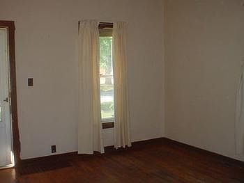 Large living room with hard wood floor.