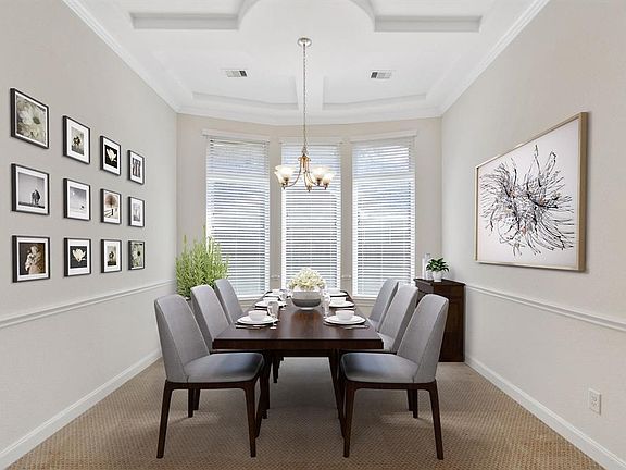 Formal dining room near to kitchen boasts beautiful ceiling detail and charming chair rail (virtually staged)