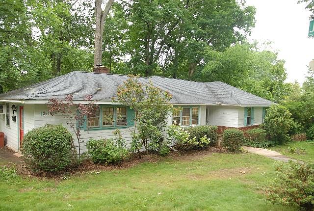 Neighborhood is a delight, and stable. On left is 2 car driveway. Also easy st parking. Private deck nestled in bamboo back yard.